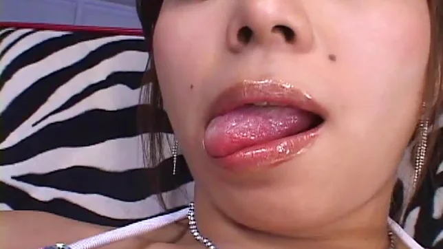 Japanese MILF Oils Up Her Big Tits And Massages Them